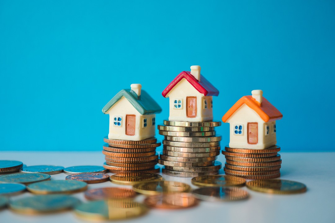 Miniature houses on stack coins